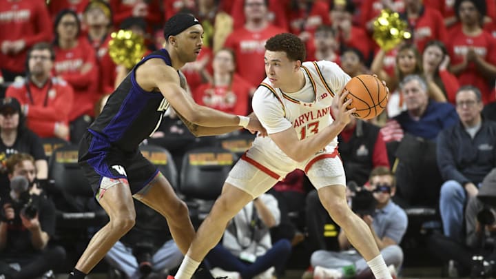 Feb 21, 2026; College Park, Maryland, USA; Maryland Terrapins forward Elijah Saunders (13) looks to pass as Washington Huskies forward Bryson Tucker (8) defends during the first half at Xfinity Center. Mandatory Credit: Tommy Gilligan-Imagn Images Feb 21, 2026; College Park, Maryland, USA; Maryland Terrapins forward Elijah Saunders (13) looks to pass as Washington Huskies forward Bryson Tucker (8) defends during the first half at Xfinity Center. Mandatory Credit: Tommy Gilligan-Imagn Images