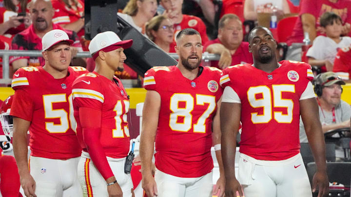 Aug 22, 2025; Kansas City, Missouri, USA; Kansas City Chiefs defensive end George Karlaftis (56) and quarterback Patrick Mahomes (15) and tight end Travis Kelce (87) and defensive tackle Chris Jones (95) watch play against the Chicago Bears during the second half of the game at GEHA Field at Arrowhead Stadium. Mandatory Credit: Denny Medley-Imagn Images