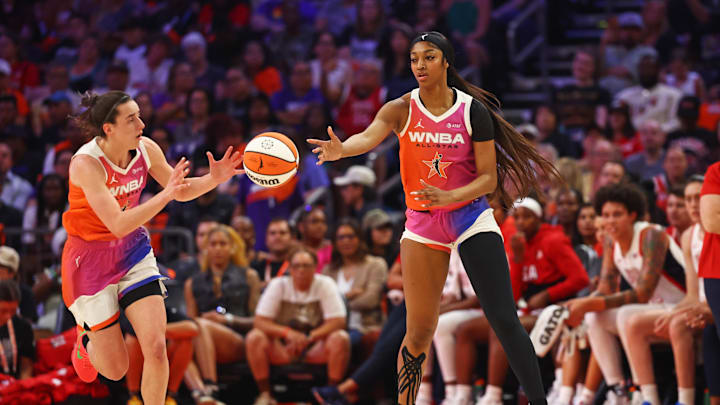 Jul 20, 2024; Phoenix, AZ, USA; Team WNBA forward Angel Reese (5) passes the ball to Team WNBA guard Caitlin Clark (22) during the first half against the USA Women's National Team at Footprint Center. Mandatory Credit: Mark J. Rebilas-Imagn Images