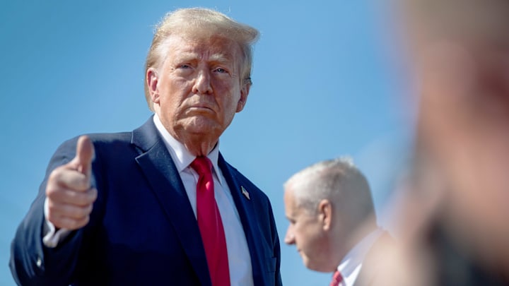 Former President Donald Trump gives a “thumbs up” to the media as he leaves following his appearance in Swannanoa, October 21, 2024.