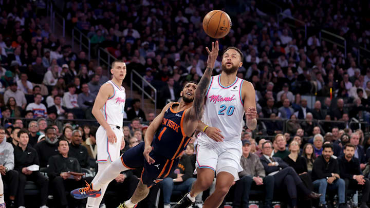 Mar 17, 2025; New York, New York, USA; New York Knicks guard Cameron Payne (1) drives to the basket against Miami Heat forward Kyle Anderson (20) and guard Tyler Herro (14) during the first quarter at Madison Square Garden. Mandatory Credit: Brad Penner-Imagn Images