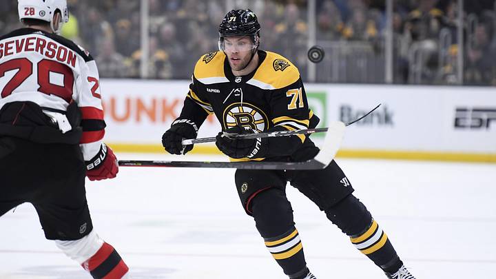 Apr 8, 2023; Boston, Massachusetts, USA; Boston Bruins left wing Taylor Hall (71) flips the puck into the offensive zone during the third period against the New Jersey Devils at TD Garden. Mandatory Credit: Bob DeChiara-Imagn Images Apr 8, 2023; Boston, Massachusetts, USA; Boston Bruins left wing Taylor Hall (71) flips the puck into the offensive zone during the third period against the New Jersey Devils at TD Garden. Mandatory Credit: Bob DeChiara-Imagn Images