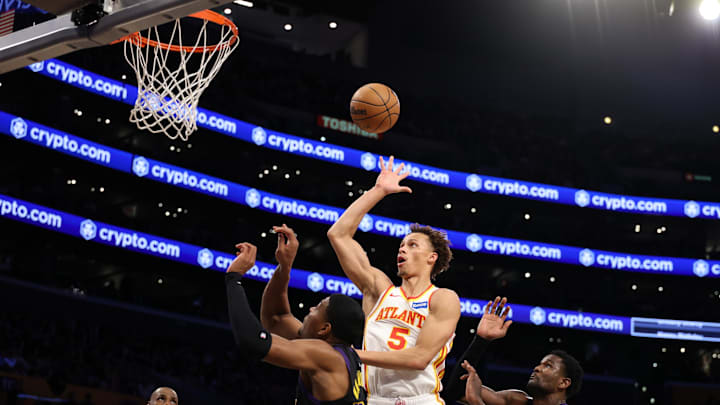 Jan 13, 2026; Los Angeles, California, USA;  Atlanta Hawks guard Dyson Daniels (5) shoots the ball between Los Angeles Lakers forward Rui Hachimura (28) and center Deandre Ayton (5) during the first half at Crypto.com Arena. Mandatory Credit: Kiyoshi Mio-Imagn Images