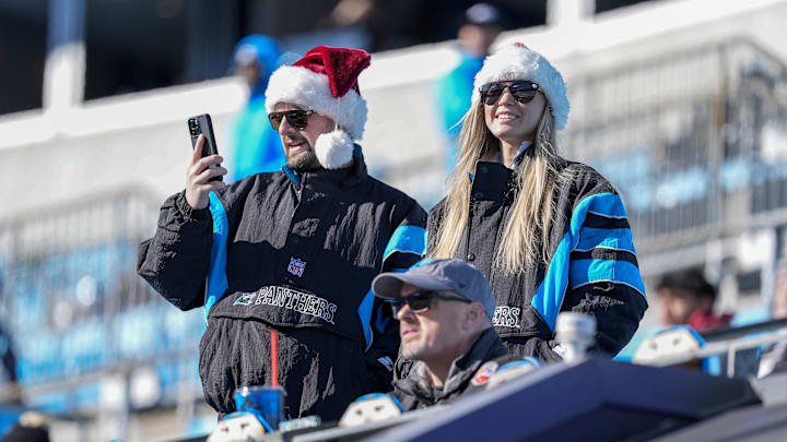 Dec 22, 2024; Charlotte, North Carolina, USA; Carolina Panthers fans in Christmas hats  during pregame warmups against the Arizona Cardinals at Bank of America Stadium. Mandatory Credit: Jim Dedmon-Imagn Images