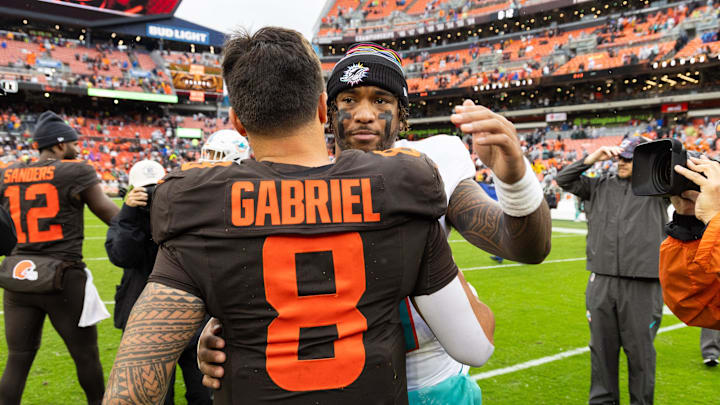 Oct 19, 2025; Cleveland, Ohio, USA; Miami Dolphins quarterback Tua Tagovailoa (1) congratulates Cleveland Browns quarterback Dillon Gabriel (8) after the game at Huntington Bank Field. Mandatory Credit: Scott Galvin-Imagn Images