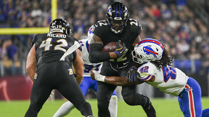 Baltimore Ravens running back Derrick Henry (22) runs through Buffalo Bills linebacker Dorian Williams' (42) tackle attempt during the first half at M&T Bank Stadium. 