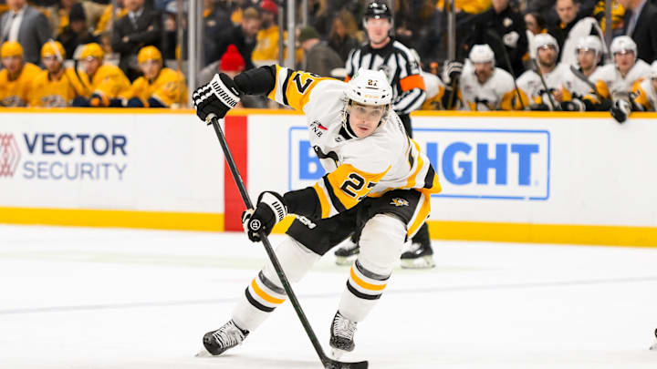 Dec 19, 2024; Nashville, Tennessee, USA;  Pittsburgh Penguins defenseman Ryan Graves (27) skates with the puck against the Nashville Predators during the second period at Bridgestone Arena. Mandatory Credit: Steve Roberts-Imagn Images