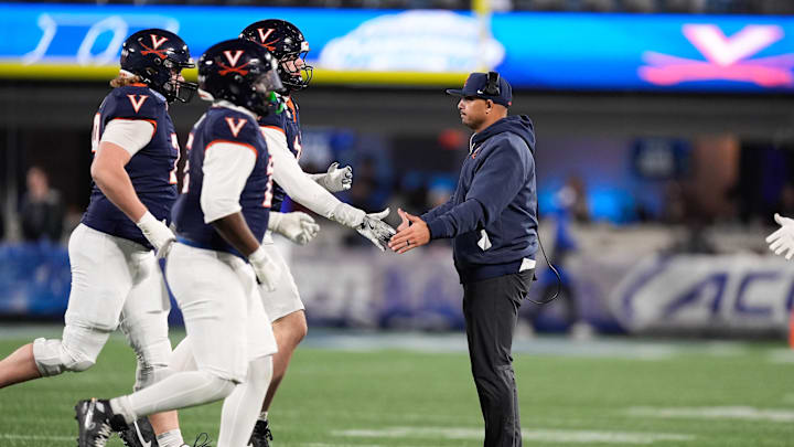 Dec 6, 2025; Charlotte, NC, USA; Virginia Cavaliers head coach Tony Elliott greets players during the second half against the Duke Blue Devils during the 2025 ACC Championship game at Bank of America Stadium. Mandatory Credit: Jim Dedmon-Imagn Images