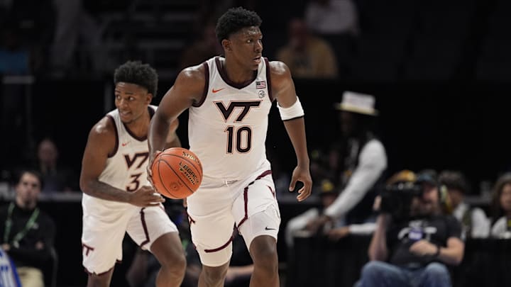 Mar 11, 2025; Charlotte, NC, USA; Virginia Tech Hokies guard Tyler Johnson (10) brings the ball up court against the California Golden Bears  during OT at Spectrum Center. Mandatory Credit: Jim Dedmon-Imagn Images 