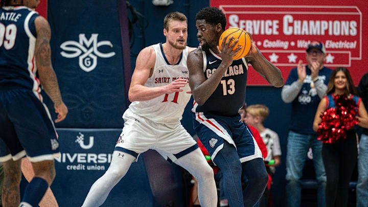 Gonzaga Bulldogs forward Graham Ike (13) controls the ball against St. Mary's Gaels center Mitchell Saxen (11).