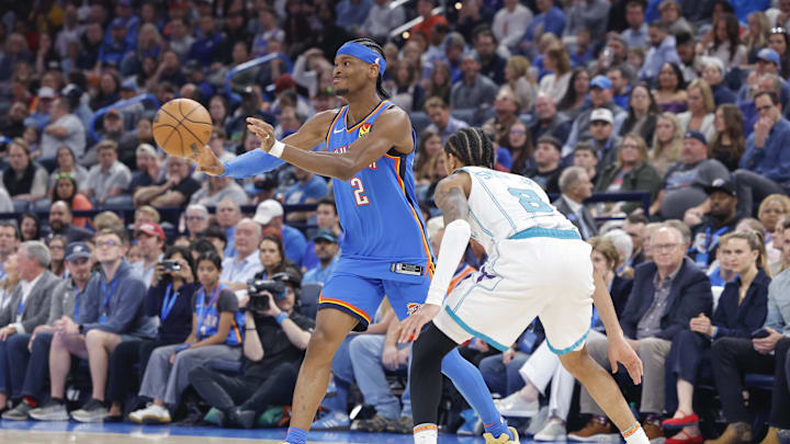 Mar 21, 2025; Oklahoma City, Oklahoma, USA; Oklahoma City Thunder guard Shai Gilgeous-Alexander (2) passes the ball during a play against Charlotte Hornets guard Nick Smith Jr. (8) during the second quarter at Paycom Center. Mandatory Credit: Alonzo Adams-Imagn Images