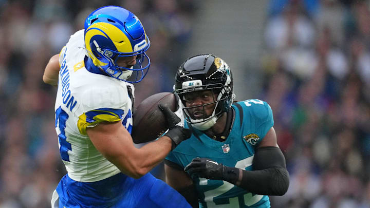 Oct 19, 2025; London, United Kingdom; Los Angeles Rams tight end Colby Parkinson (84) makes a catch against Jacksonville Jaguars safety Rayuan Lane III (25) during the first half of an NFL International Series game at Wembley Stadium. Mandatory Credit: Kirby Lee-Imagn Images