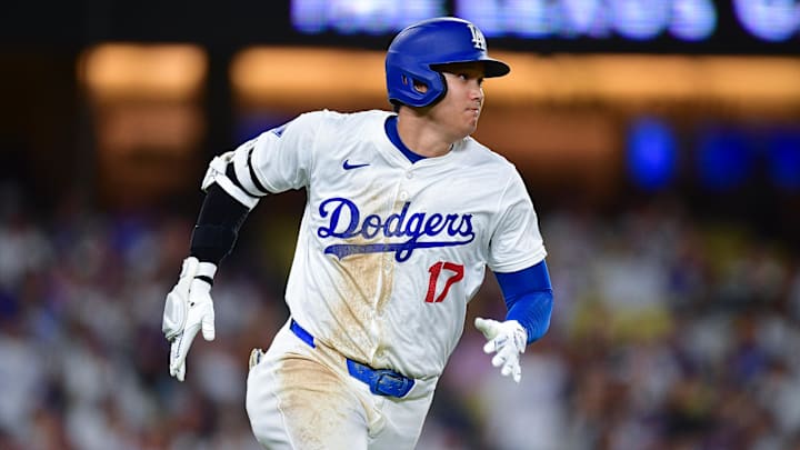 Sep 9, 2024; Los Angeles, California, USA; Los Angeles Dodgers designated hitter Shohei Ohtani (17) runs after hitting a single against the Chicago Cubs during the seventh inning at Dodger Stadium. Mandatory Credit: Gary A. Vasquez-Imagn Images