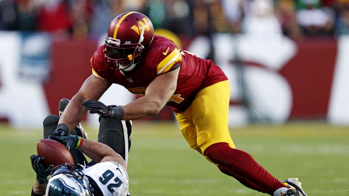 Dec 22, 2024; Landover, Maryland, USA; Philadelphia Eagles running back Saquon Barkley (26) drops a pass against Washington Commanders linebacker Bobby Wagner (54) during the fourth quarter at Northwest Stadium. Mandatory Credit: Peter Casey-Imagn Images