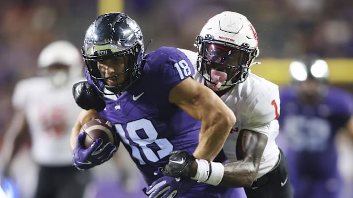 CU Horned Frogs wide receiver Jack Bech (18) breaks the tackle of Houston Cougars defensive back Latrell McCutchin Sr. (1) and scores a touchdown in the fourth quarter at Amon G. Carter Stadium. 