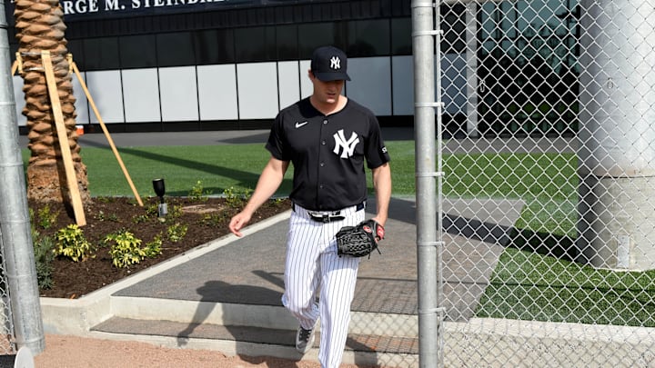 New York Yankees pitcher Gerrit Cole (45) walks on to the field before the start of a spring training workout  at George M. Steinbrenner Field in 2025.