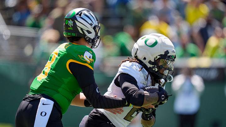 Fighting Ducks quarterback Dylan Raiola, left, hands off the ball to Fighting Ducks running back Dierre Hill Jr. during the Oregon Ducks annual spring game on April 25, 2026 at Autzen Stadium in Eugene, Oregon.