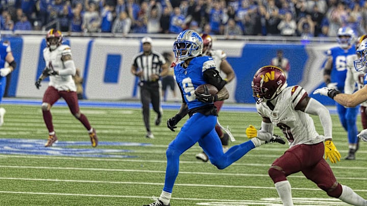 Jan 18, 2025; Detroit, Michigan, USA;  Detroit Lions wide receiver Jameson Williams (9) carries the ball against Washington Commanders corner back Mike Sainristil (0) during the second quarter at Ford Field. Mandatory Credit: David Reginek-Imagn Images
