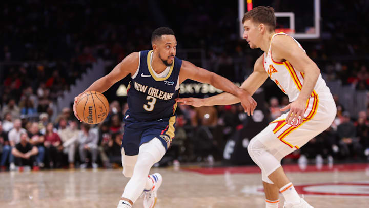 Dec 2, 2024; Atlanta, Georgia, USA; New Orleans Pelicans guard CJ McCollum (3) is defended by Atlanta Hawks guard Bogdan Bogdanovic (13) in the fourth quarter at State Farm Arena. Mandatory Credit: Brett Davis-Imagn Images