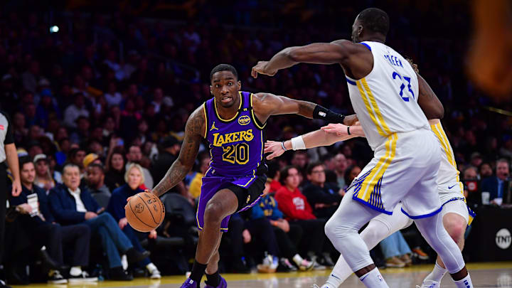 Feb 6, 2025; Los Angeles, California, USA; Los Angeles Lakers guard Shake Milton (20) moves to the basket against Golden State Warriors forward Draymond Green (23) during the first half at Crypto.com Arena. Mandatory Credit: Gary A. Vasquez-Imagn Images