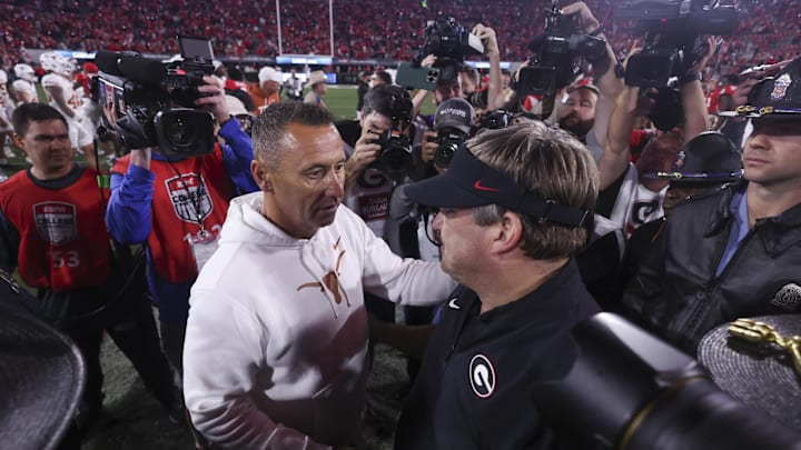 Athens, Georgia, USA; Texas Longhorns head coach Steve Sarkisian and Georgia Bulldogs head coach Kirby Smart interact after a game at Sanford Stadium.