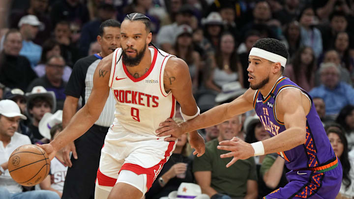 Houston Rockets forward Dillon Brooks drives past Phoenix Suns guard Devin Booker.