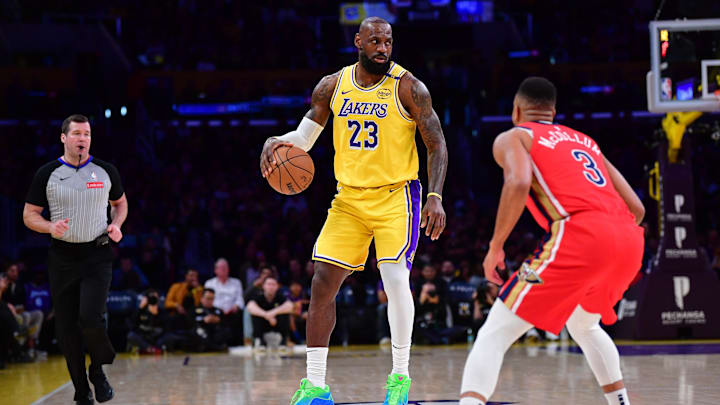 Mar 4, 2025; Los Angeles, California, USA; Los Angeles Lakers forward LeBron James (23) moves the ball against New Orleans Pelicans guard CJ McCollum (3) during the first half at Crypto.com Arena. Mandatory Credit: Gary A. Vasquez-Imagn Images