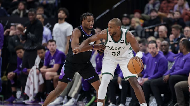 Jan 27, 2025; Salt Lake City, Utah, USA;  Milwaukee Bucks forward Khris Middleton (22) controls the ball as Utah Jazz guard Isaiah Collier (13) defends during the second half at Delta Center. Mandatory Credit: Chris Nicoll-Imagn Images