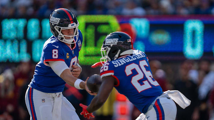 New York Giants quarterback Daniel Jones (8) hands the ball off to New York Giants running back Devin Singletary (26) during a game between the New York Giants and the Washington Commanders at MetLife Stadium in East Rutherford on Sunday, Nov. 3, 2024. New York Giants quarterback Daniel Jones (8) hands the ball off to New York Giants running back Devin Singletary (26) during a game between the New York Giants and the Washington Commanders at MetLife Stadium in East Rutherford on Sunday, Nov. 3, 2024.