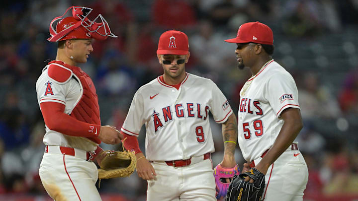 Apr 6, 2026; Anaheim, California, USA; Los Angeles Angels catcher Logan O'Hoppe (14) and shortstop Zach Neto (9) meet at the mound with starting pitcher Jose Soriano (59) during the seventh inning against the Atlanta Braves at Angel Stadium. Mandatory Credit: Jayne Kamin-Oncea-Imagn Images