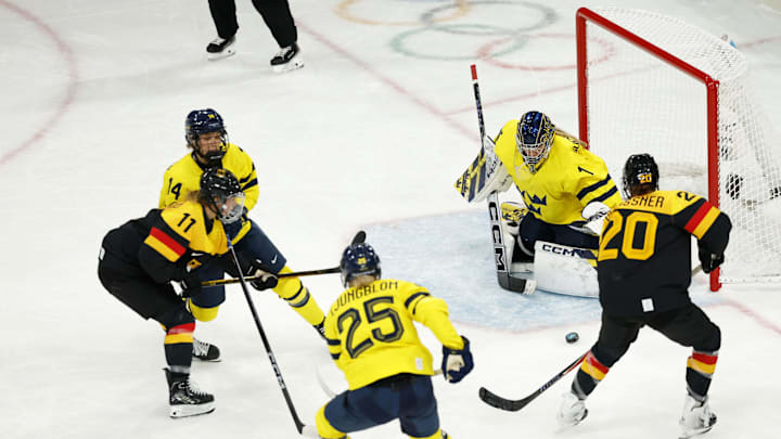 Feb 5, 2026; Milan, Italy; Daria Gleissner (20) of Team Germany shoots the puck against Ebba Svensson Traff (1) of Team Sweden in a women's ice hockey Group B game during the Milano Cortina 2026 Olympic Winter Games at Milano Rho Ice Hockey Arena. Mandatory Credit: Geoff Burke-Imagn Images Feb 5, 2026; Milan, Italy; Daria Gleissner (20) of Team Germany shoots the puck against Ebba Svensson Traff (1) of Team Sweden in a women's ice hockey Group B game during the Milano Cortina 2026 Olympic Winter Games at Milano Rho Ice Hockey Arena. Mandatory Credit: Geoff Burke-Imagn Images