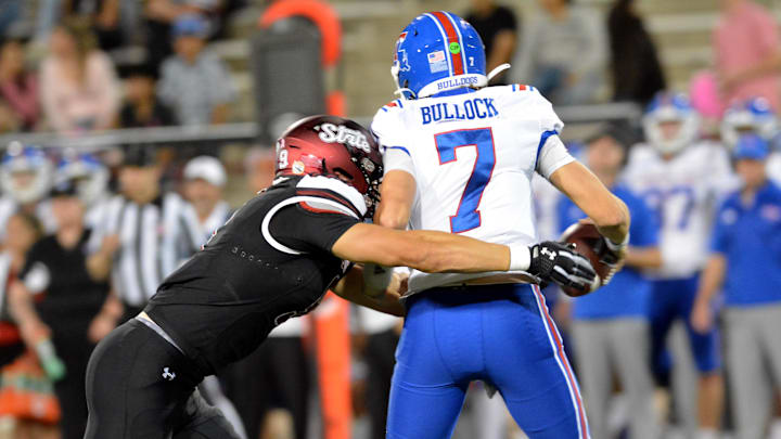 New Mexico State's Kale Edwards (left) tackles the LaTech quarter back for a loss as the NMSU Aggies took on the Louisiana Tech Bulldogs, Tuesday night at Aggie Memorial Stadium, October 15, 2024. New Mexico State's Kale Edwards (left) tackles the LaTech quarter back for a loss as the NMSU Aggies took on the Louisiana Tech Bulldogs, Tuesday night at Aggie Memorial Stadium, October 15, 2024.