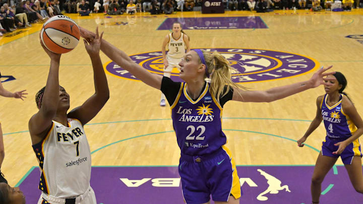 May 24, 2024; Los Angeles, California, USA;  Los Angeles Sparks forward Cameron Brink (22) blocks a shot by Indiana Fever forward Aliyah Boston (7) in the first half at Crypto.com Arena. Mandatory Credit: Jayne Kamin-Oncea-Imagn Images