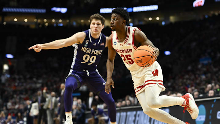 Mar 19, 2026; Portland, OR, USA; Wisconsin Badgers guard John Blackwell (25) drives to the basket against High Point Panthers guard Chase Johnston (99) during the second half of a first round game of the men's 2026 NCAA Tournament at Moda Center.
