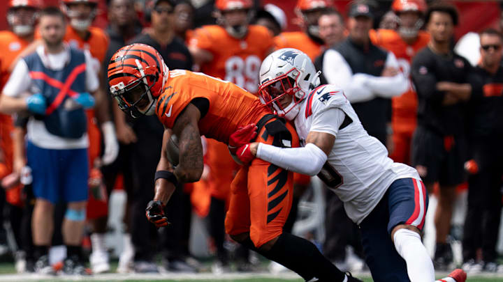 Cincinnati Bengals wide receiver Ja'Marr Chase (1) is tackled by New England Patriots corner back Christian Gonzalez (0) in the second quarter of the NFL game at Paycor Stadium in Cincinnati on Sunday, Sept. 8, 2024. Cincinnati Bengals wide receiver Ja'Marr Chase (1) is tackled by New England Patriots corner back Christian Gonzalez (0) in the second quarter of the NFL game at Paycor Stadium in Cincinnati on Sunday, Sept. 8, 2024.