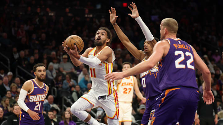 Jan 9, 2025; Phoenix, Arizona, USA; Atlanta Hawks guard Trae Young (11) drives to the basket against the Phoenix Suns in the second half at Footprint Center. Mandatory Credit: Mark J. Rebilas-Imagn Images