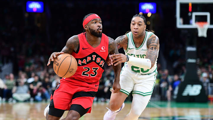 Oct 13, 2024; Boston, Massachusetts, USA;  Toronto Raptors guard Jamal Shead (23) controls the ball while Boston Celtics guard JD Davison (20) defends during the second half at TD Garden. Mandatory Credit: Bob DeChiara-Imagn Images
