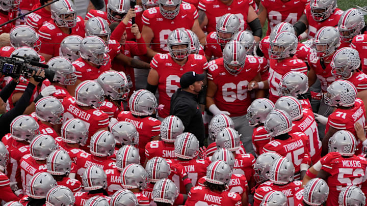 Ohio State coach Ryan Day huddles with his players before facing Maryland.