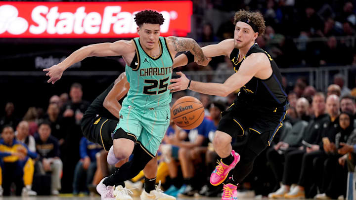 Feb 25, 2025; San Francisco, California, USA; Charlotte Hornets guard KJ Simpson (25) and Golden State Warriors guard Brandin Podziemski (2) chase a loose ball in the third quarter at the Chase Center. Mandatory Credit: Cary Edmondson-Imagn Images