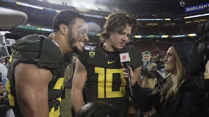 Dec 6, 2019; Santa Clara, CA, USA; Oregon Ducks linebacker Troy Dye (35) and quarterback Justin Herbert (10)