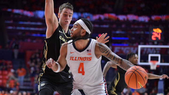 Nov 13, 2024; Champaign, Illinois, USA;  Illinois Fighting Illini guard Kylan Boswell (4) drives the ball against Oakland Golden Grizzlies guard Jayson Goodrich (11) during the first half at State Farm Center. Mandatory Credit: Ron Johnson-Imagn Images
