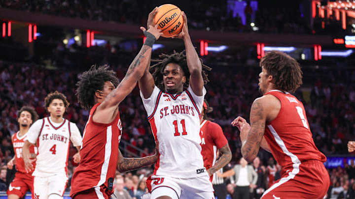 Nov 8, 2025; New York, New York, USA; St. John's basketball guard Ian Jackson (11) looks to drive past Alabama Crimson Tide guard Aden Holloway (2) and forward Amari Allen (5) in the second half at Madison Square Garden. Nov 8, 2025; New York, New York, USA; St. John's basketball guard Ian Jackson (11) looks to drive past Alabama Crimson Tide guard Aden Holloway (2) and forward Amari Allen (5) in the second half at Madison Square Garden.