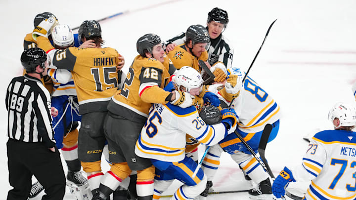 A scrum breaking out after Brayden McNabb delivered a hit to Zach Benson