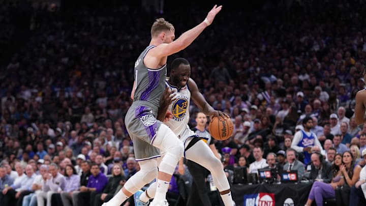 Apr 26, 2023; Sacramento, California, USA; Golden State Warriors forward Draymond Green (23) dribbles next to Sacramento Kings forward Domantas Sabonis (10) in the third quarter during game five of the 2023 NBA playoffs at the Golden 1 Center. Mandatory Credit: Cary Edmondson-Imagn Images
