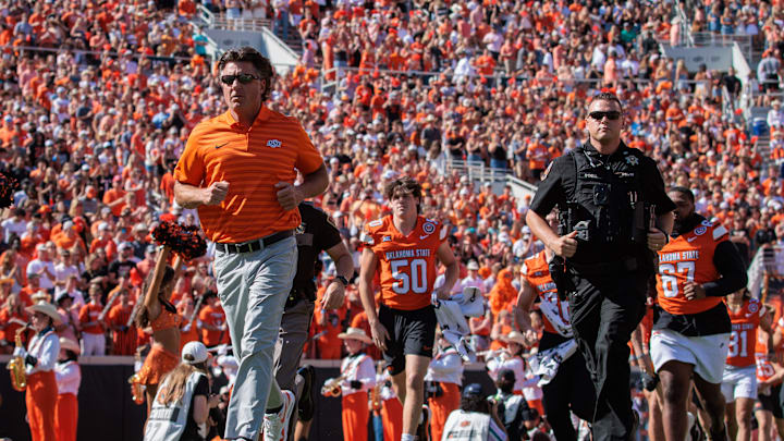 Oct 5, 2024; Stillwater, Oklahoma, USA; Oklahoma State Cowboys coach Mike Gundy enters the field for a game against the West Virginia Mountaineers at Boone Pickens Stadium. Mandatory Credit: William Purnell-Imagn Images Oct 5, 2024; Stillwater, Oklahoma, USA; Oklahoma State Cowboys coach Mike Gundy enters the field for a game against the West Virginia Mountaineers at Boone Pickens Stadium. Mandatory Credit: William Purnell-Imagn Images