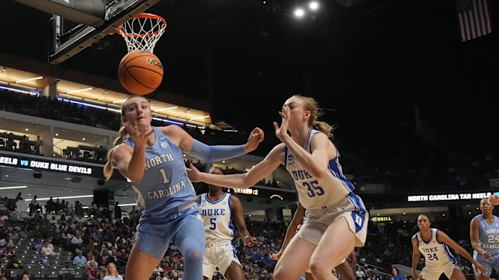 North Carolina Tar Heels forward Alyssa Ustby (1) saves a ball inbound as Duke Blue Devils forward Toby Fournier (35) pursues at Legacy Arena. North Carolina Tar Heels forward Alyssa Ustby (1) saves a ball inbound as Duke Blue Devils forward Toby Fournier (35) pursues at Legacy Arena.