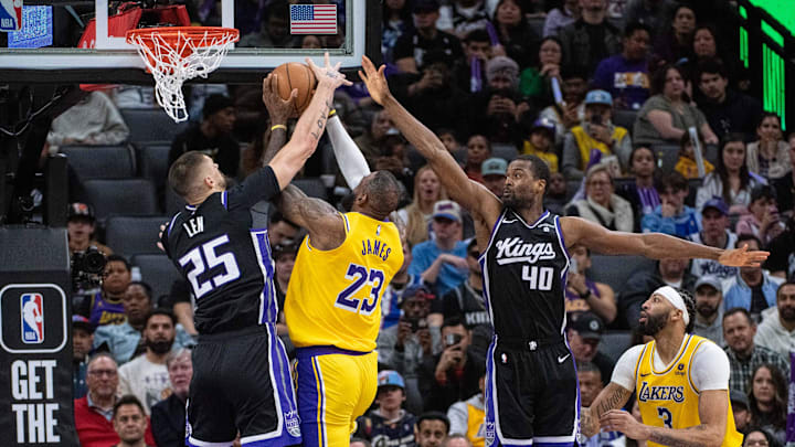 Mar 13, 2024; Sacramento, California, USA; Los Angeles Lakers forward LeBron James (23) is fouled on his way to the basket by Sacramento Kings center Alex Len (25) during the fourth quarter at Golden 1 Center. 