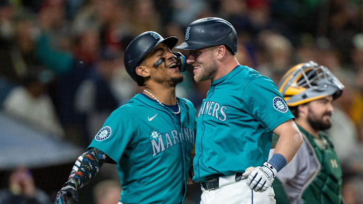 Seattle Mariners first baseman Luke Raley (20) celebrates with centerfielder Julio Rodriguez (44), left, after hitting a two-run home run during the ninth inning against the Oakland Athletics at T-Mobile Park in 2024.