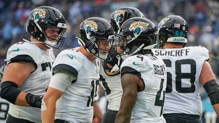 Jacksonville Jaguars quarterback Mac Jones (10) celebrates with running back Tank Bigsby (4) after Bigsby ran in a touchdown in the fourth quarter at Nissan Stadium in Nashville, Tenn., Sunday, Dec. 8, 2024.