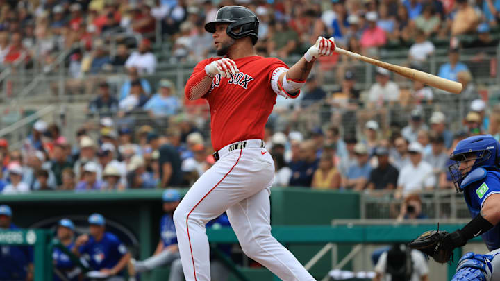 Feb 22, 2026; Fort Myers, Florida, USA; Boston Red Sox first baseman Willson Contreras (40) hits a sacrifice RBI during the first inning against the Toronto Blue Jays  at JetBlue Park at Fenway South. Mandatory Credit: Kim Klement Neitzel-Imagn Images